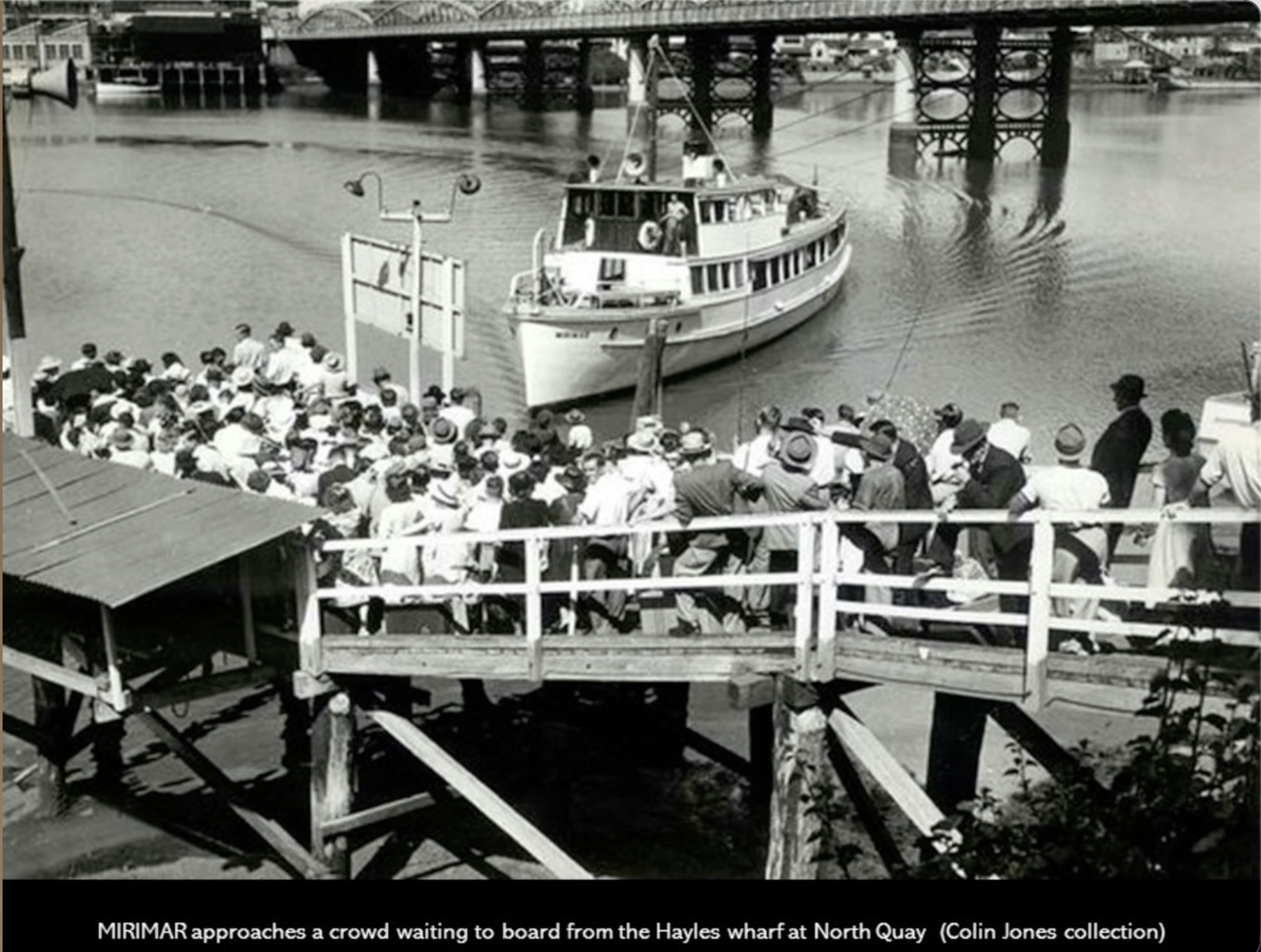 The Original MIRIMAR at Hayles Wharf, North Quay Historic black and white photograph of the original MIRIMAR passenger vessel approaching Hayles Wharf at North Quay, Brisbane, with a large crowd of passengers waiting to board. The image captures Brisbane's early river transport history and the beginnings of the MIRIMAR legacy on the Brisbane River.